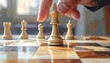 © sakura - A hand strategically positions a light-colored chess king on a polished wooden chessboard, suggesting a moment of critical decision-making in a  of chess.