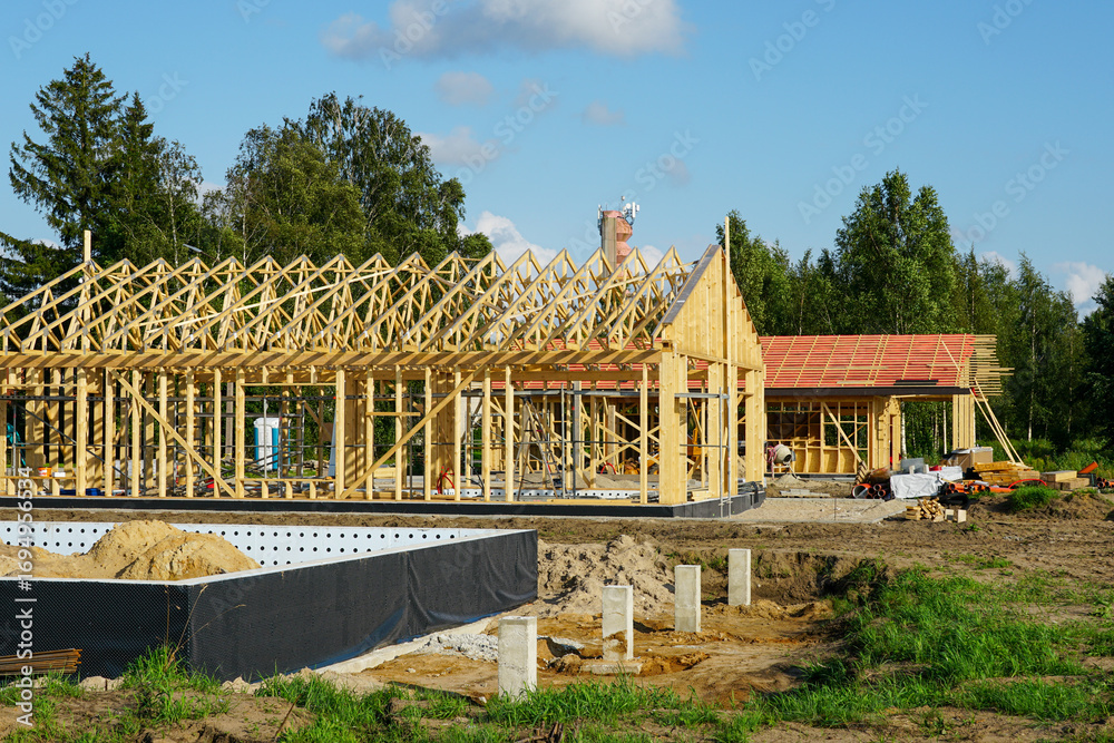 ICF foundation and wooden house frame construction with roof trusses at ...