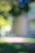 © Lina - A dreamy view of a sidewalk leading towards a building.
