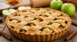 © Masaji - A close up of a lattice topped apple pie with apples and cinnamon sticks on a wooden surface top