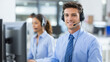 © Elif Taran - Happy male customer service representative working with a colleague in a modern call center