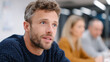 © Sergey - Man engaged in meeting discussion with colleagues blurred in the background