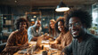 © Meta Design  - Diverse group of smiling people gathered around a table in a bright office setting