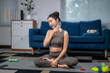 © Apichat - Young asian woman cooling down after home workout with water bottle