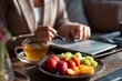 © Starlight - A businesswoman reviewing her schedule while stirring tea, the plate has fresh fruit, the mood feels calm and intentional, Generative AI