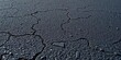 © Chavankorn - Dark, coarse-grained asphalt surface, showing fine cracks and texture,  aged,   bitumen texture