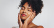 © Azee25/peopleimages.com - Beauty, calm and woman with lipstick, studio or color for self expression, moisturizer or cosmetics. White background, relax and skincare with dermatology for black person, makeup and glow of face