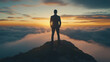 © dewaai - Businessman standing on mountain peak above clouds at sunrise, symbolizing success, achievement, and leadership in a dramatic scenic landscape