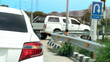 Rear side of white car with right turn signal. Open for u-turn on the road. Front of car the other car waiting for u-turn and sign board for u-turn. Background of city under blue sky.