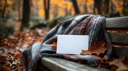 Wall Mural - cozy autumn park bench with plaid blanket and blank card