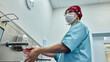 © Georgii - Healthcare professional washing hands in preparation for medical surgery in hospital
