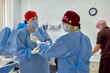© Georgii - Medical team preparing for surgery in a sterile operating room