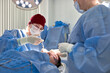 © Georgii - Medical professionals performing a procedure in a sterile operating room