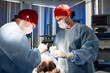 © Georgii - Healthcare professionals performing a surgical procedure in a modern clinic