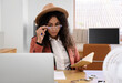 © Pixel-Shot - Female African-American spy with notebook and laptop at table in office