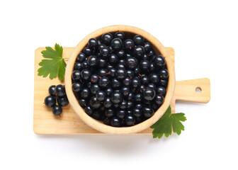 Wall Mural - wooden bowl and board with fresh black currants on white background