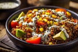 Quinoa salad in a bowl with avocado corn tomatoes and a creamy dressing