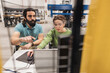 © Westend61 - Engineer gesturing colleague working on laptop in factory