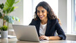 © Gunawan - Smiling businesswoman working on laptop, productive and happy