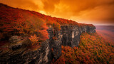 Breathtaking Autumn View with Golden Trees on a Rocky Cliff