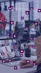 Wall Mural - animation of globe of digital icons spinning over man having video call on laptop at office