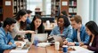 © rifqi - Diverse Students Collaborating on Laptops in a Bright Library Study Group Session.