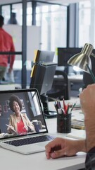 Wall Mural - animation of digital icons over business people on laptop video call