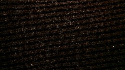 Wall Mural - close-up textured brown fabric with fine ribbed pattern illuminated by soft light ideal for wallpaper or commercial background use