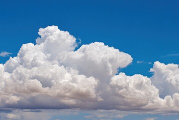 Wall Mural - Fluffy white cumulonimbus clouds drift in an azure sky. Lower clouds show faint earth tones. A serene, airy, and expansive vista