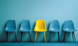 © fannybuddhies - Yellow chair stands out among blue chairs in a waiting room, symbolizing individuality and standing out from the crowd with a bright and optimistic feeling.