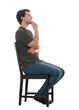© 1STunningART - Side view casual guy seated on a chair keeps hand under chin thoughtful looking away, has a lot of plans and goals. Positive male full length portrait isolated on transparent background