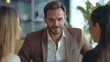 © reifansyah - Confident businessman in a meeting with diverse women in a modern office