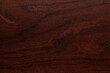 Close-up of luxurious mahogany wood showcasing its rich hues and detailed grain, ideal for enhancing any space with elegance.