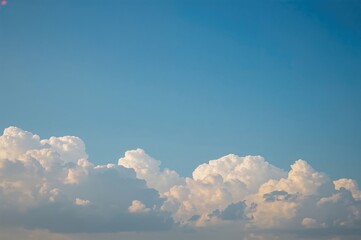 Wall Mural - Daytime scene with clear blue sky and fluffy white clouds in a natural setting