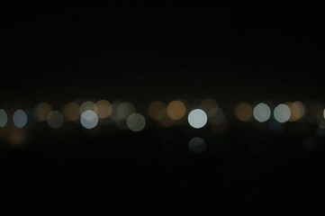 Wall Mural - defocused light spots against a dark backdrop