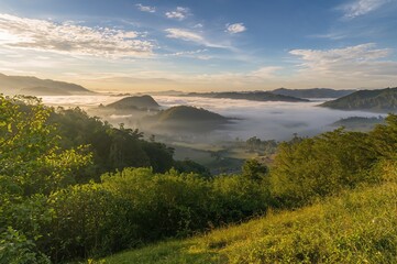 Wall Mural - sunrise light and fog over mountain landscape