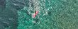 © aerial-drone - Aerial drone ultra wide photo of couple practice Stand Up Paddle board or SUP surf in tropical exotic island bay with emerald crystal clear sea