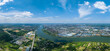 Suizhou City China shows buildings by the river under a bright blue sky with white clouds.