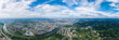 Cityscape panorama shows buildings and a river flowing through the urban landscape of Suizhou City, China under a bright sky.