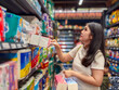 © Apichat - A woman is shopping in a store and is looking at the toilet paper section