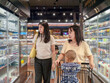 © Apichat - woman with a child in a shopping cart is shopping in a grocery store