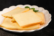 © Alesia Berlezova - Raclette cheese portion slicing natural product tasty snack fresh delicious gourmet food background on the table rustic top view copy space