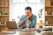 © Miljan Živković - Tired freelancer eating lunch and working from home office