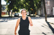 © Louis-Paul Photo - woman running outdoors, middle aged woman in sportswear.