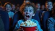 © miss irine - Young child with wide eyes, open mouth expresses shock, excitement holding popcorn bucket in dark movie theater. Children watch screen. Cinematic experience, entertainment, youth emotion, pure joy,