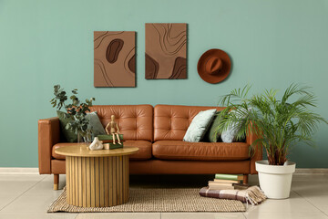 Wall Mural - Comfortable sofa, coffee table and houseplants in interior of living room