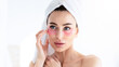 © Prostock-studio - Facial care during covid-19 lockdown, cosmetics and spa day for natural beauty. Pretty sexy 30s female wrapped in towel, puts patches under her eyes and looks in mirror, in bathroom, empty space