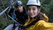 © Milos - A young man and woman grasp safety gear excitedly while getting ready to zip-line through a breathtaking forest, showcasing their adventurous spirit and teamwork.