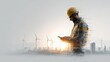 © pingpao - A construction worker in a safety helmet checks his phone against an industrial backdrop featuring wind turbines and factories during sunset.