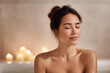 © Levan - woman immersed in peaceful bathroom ambiance surrounded by softly glowing aroma candles